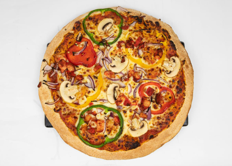 Jonaldo’s whole round pizza topped with various vegetables and meat.